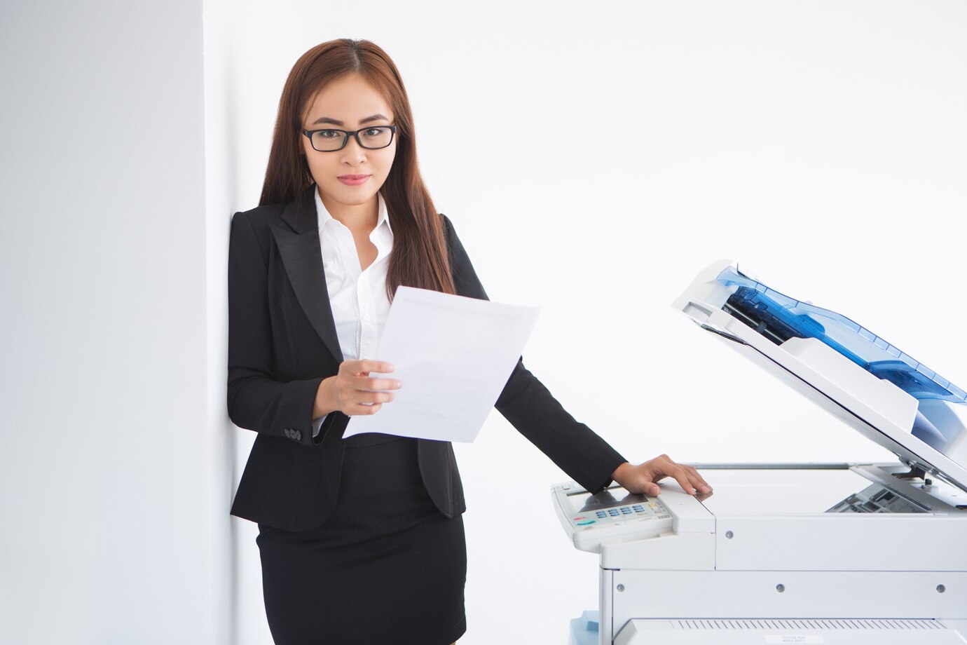 Office assistant girl using Canon copier at workplace