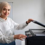 Office woman using printer supplied by Canon printer seller in Russia